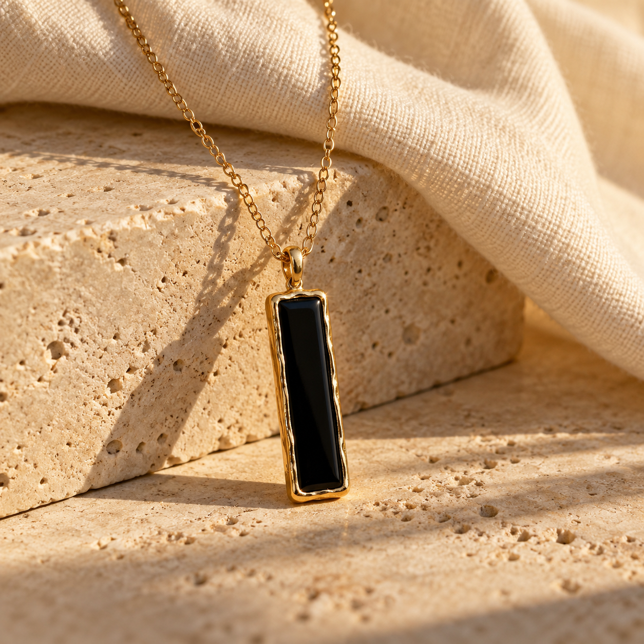 Kivuli necklace with slim rectangular black onyx framed in gold