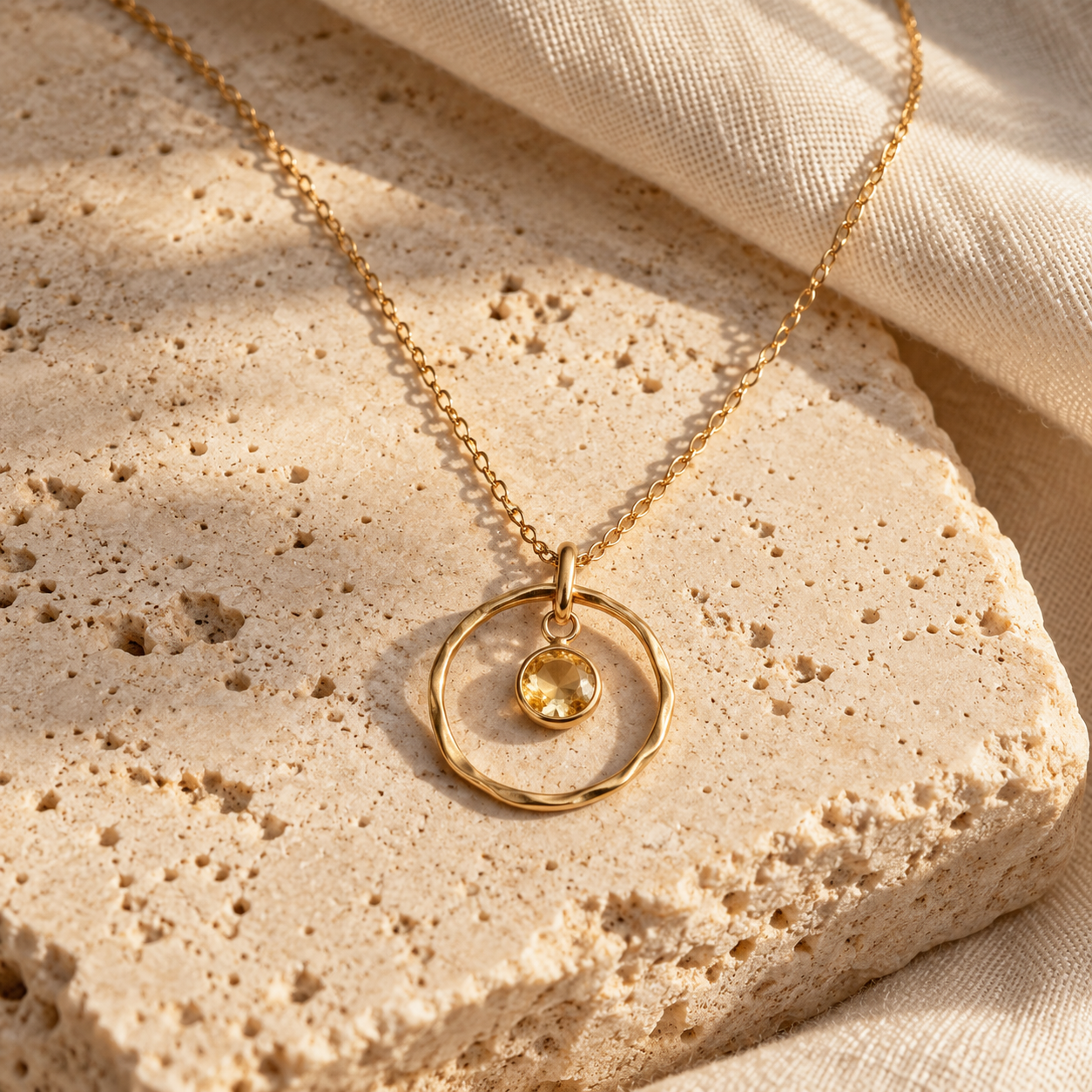Delicate Kito circular gold pendant centred on a small pale citrine